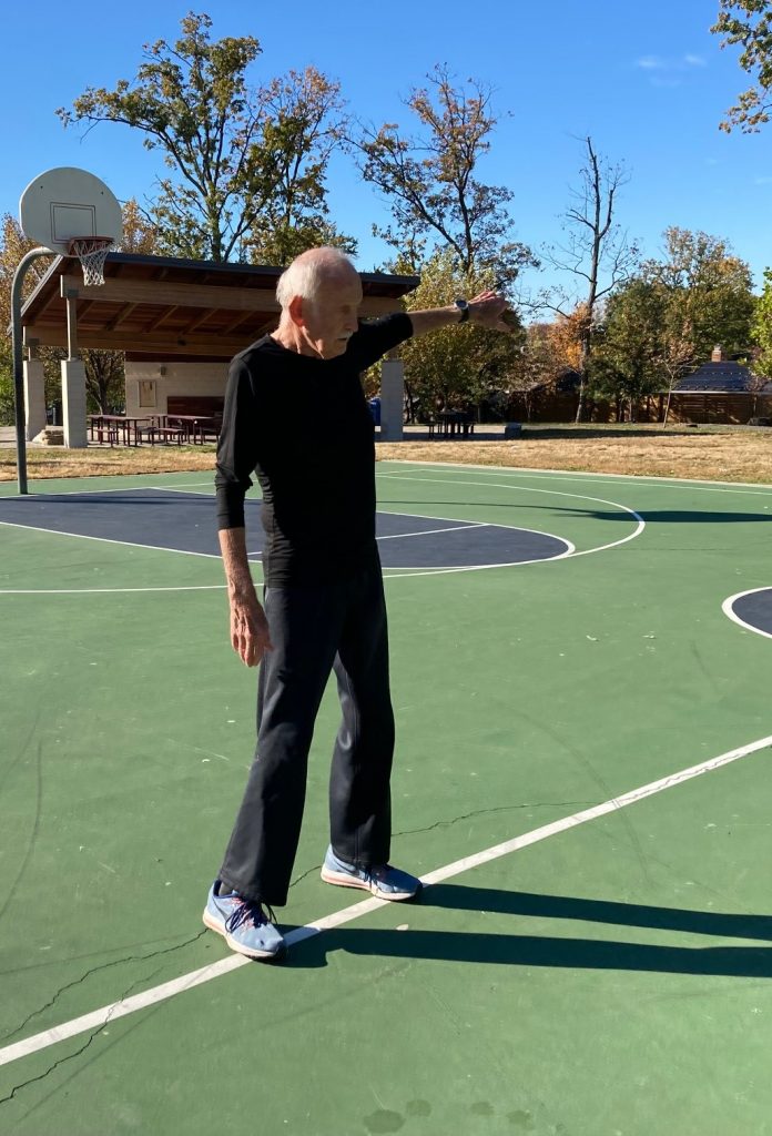 A man stands on a basketball court